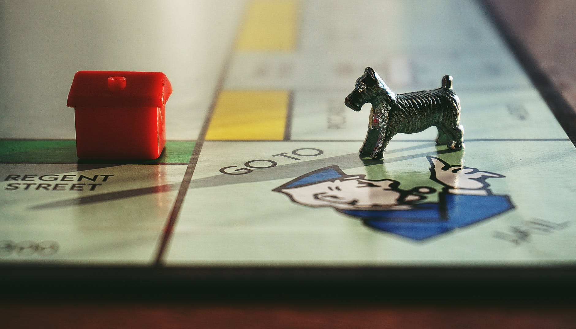 miniature toy on monopoly board game