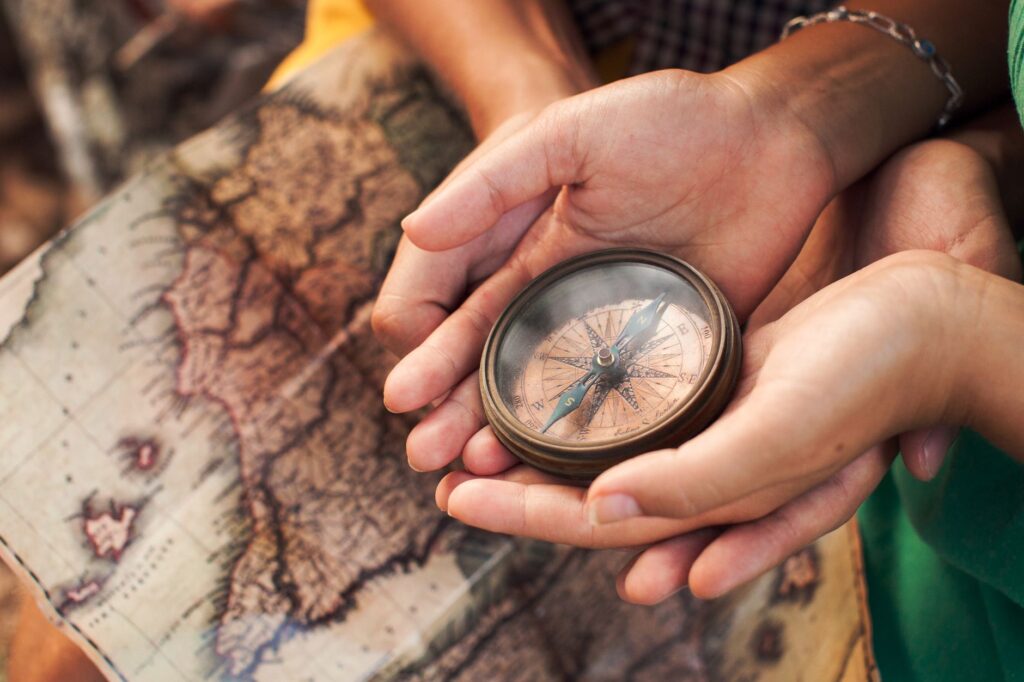 a couple holding a round compass